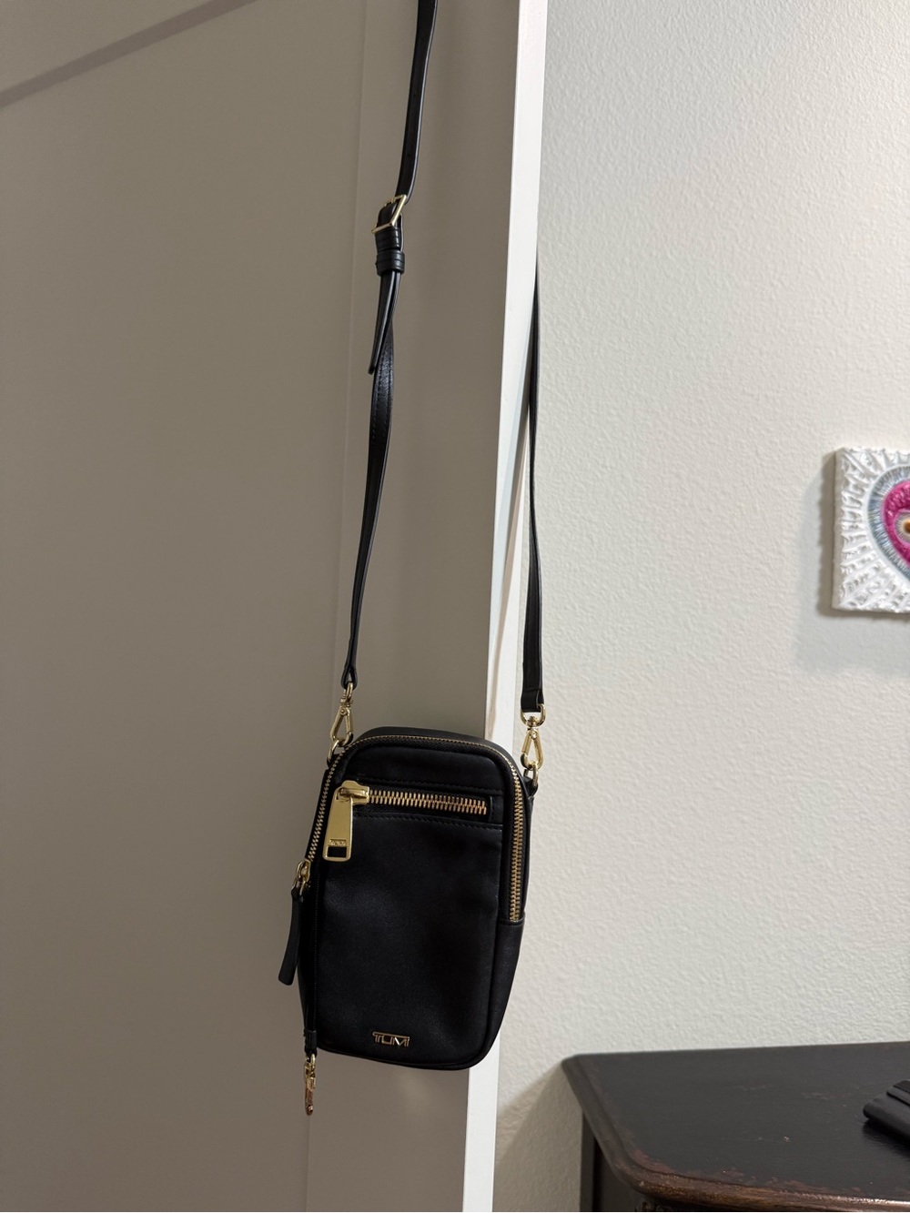 Tumi Black Leather Crossbody Phone Pouch with Gold Hardware